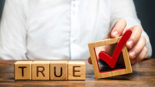 man holding checkmark next to the words true